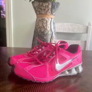 Nike Pink and Silver Athletic Shoes with Sleek Design