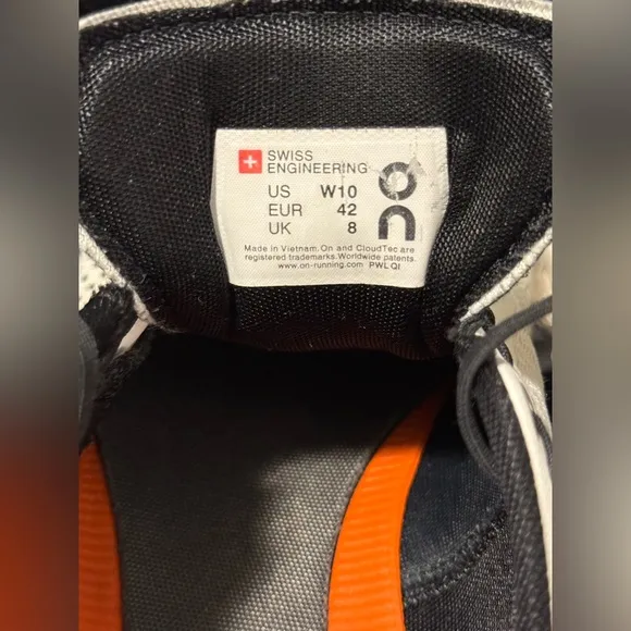On Running White and Black Sneakers with Cloud Cushioning