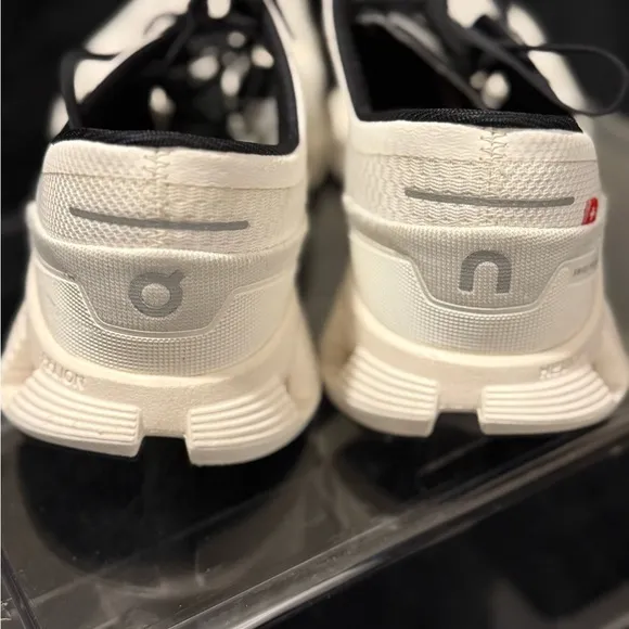 On Running White and Black Sneakers with Cloud Cushioning