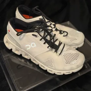 On Running White and Black Sneakers with Cloud Cushioning