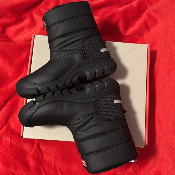 These are a pair of all black insulated Hunter snow boots size 1