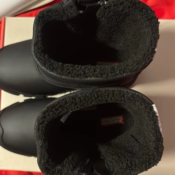 These are a pair of all black insulated Hunter snow boots size 1