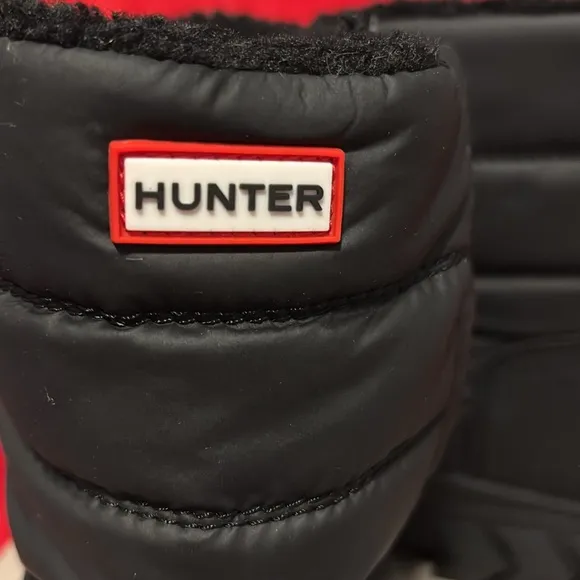 These are a pair of all black insulated Hunter snow boots size 1