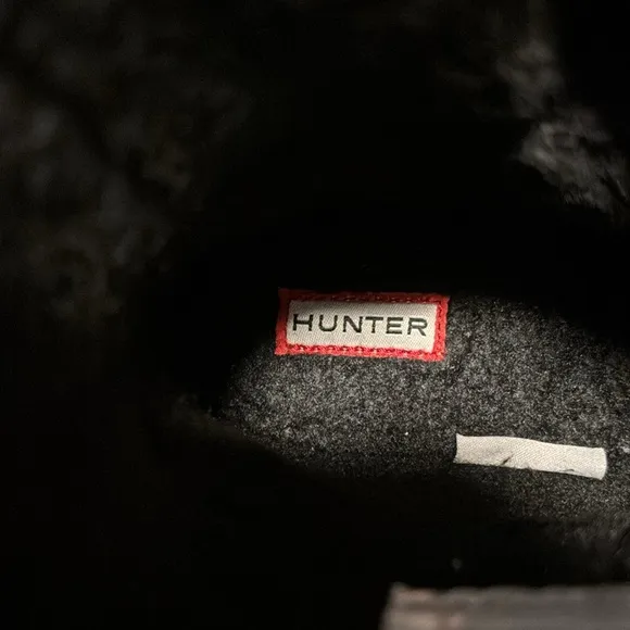 These are a pair of all black insulated Hunter snow boots size 1